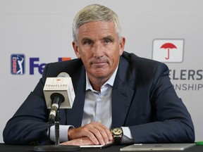 FILE - PGA Tour Commissioner Jay Monahan speaks during a news conference before the start of the Travelers Championship golf tournament at TPC River Highlands, Wednesday, June 22, 2022, in Cromwell, Conn. The most disruptive year in golf ended Tuesday, June 6, 2023, when the PGA Tour and European tour agreed to a merger with Saudi Arabia's golf interests, creating a commercial operation designed to unify professional golf around the world.