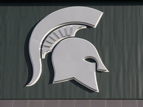 FILE - Michigan State's logo hangs on Spartan Stadium before the start of an NCAA college football game between Michigan State and Tulsa, on Aug. 30, 2019, in East Lansing, Mich. Michigan State University's $3.9 billion endowment fund has become the majority investor in Detroit's iconic Fisher Building, according to an announcement Tuesday, June 13, 2023. The fund is staking $21 million into the building and several other properties for a 79% ownership stake.