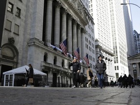 FILE - People pass the front of the New York Stock Exchange in New York, March 21, 2023. Stocks are dipping on Wall Street, Wednesday, April 5, and Treasury yields are dropping following the latest signals that the U.S. economy is slowing under the weight of much higher interest rates.