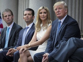 FILE - Donald Trump, right, sits with his children, from left, Eric Trump, Donald Trump Jr., and Ivanka Trump during a groundbreaking ceremony for the Trump International Hotel on July 23, 2014, in Washington. A New York appeals court dismissed Ivanka Trump on Tuesday, June 27, 2023, from a wide-ranging fraud lawsuit brought against her father and his company last year by the state's attorney general.