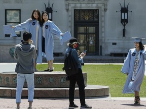 File - Columbia University class of 2020 graduates pose for photographs on Commencement Day on Wednesday, May 20, 2020, in New York. After three years, the pandemic-era freeze on student loan payments will end in late August. It might seem tempting to just keep not making payments, but the consequences can be severe, including a hit to your credit score and exclusion from future aid and benefits.