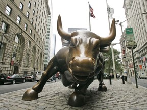 FILE- This Oct. 18, 2008 file photo shows the Charging Bull sculpture in New York City's Financial District. The S&P 500 is now in what Wall Street refers to as a bull market, meaning the index has risen 20% or more from its most recent low.