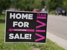 A for sale sign stands outside a single-family residence on the market Sunday, June 18, 2023, in Denver. On Thursday, the National Association of Realtors reports on sales of existing homes in May.