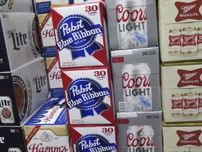 FILE - In this Nov. 8, 2018, file photo, cases of beer are stacked next to each other in a Milwaukee liquor store. Wisconsin's alcohol industry is getting behind an overhaul of the state's alcohol laws that would lead to stricter enforcement efforts The measure has been hammered out in secret the past five years largely between Republican lawmakers and the multi-billion dollar alcohol industry.
