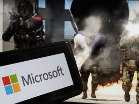 The logo for Microsoft, and a scene from Activision "Call of Duty - Modern Warfare," are shown in this photo, in New York, Wednesday, June 21, 2023. Microsoft on Thursday will try to gain clearance to complete a $69 billion takeover of video game maker Activision Blizzard in a legal showdown with U.S. regulators that will reshape a pastime that's bigger than the movie and music industries combined.