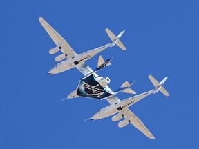 FILE - Virgin Galactic's VSS Unity departs Mojave Air & Space Port in Mojave, Calif., for the final time as Virgin Galactic shifts its SpaceFlight operations to New Mexico, Feb. 13, 2020. Virgin Galactic announced Wednesday, June 14, 2023, that monthly commercial flights to the edge of space will begin for ticket-holders in August, following a research flight planned for the end of June.