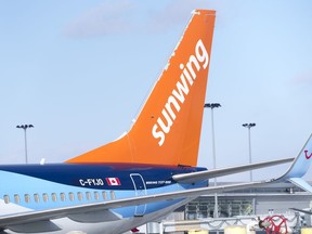 A Sunwing aircraft is parked at Montreal Trudeau airport in Montreal on Wednesday, March 2, 2022.. WestJet is planning to wind down Sunwing Airlines, integrating the low-cost carrier into its mainline business within two years.