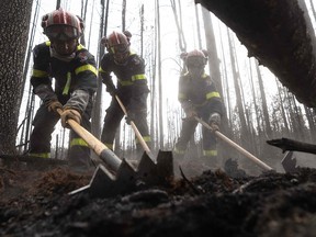 Firefighters from France help battle fires in Quebec this month. Several miners had to stop operations as Canada grappled with one of the worst starts to its wildfire season.