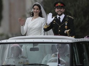 FILE - Jordan's Crown Prince Hussein and Saudi Rajwa Alseif wave to well-wishers during their wedding ceremonies in Amman, Jordan, on June 1, 2023. Their royal wedding represented the pinnacle of the monarchy's efforts to establish Hussein as the face of Jordan's next generation, a future king who can modernize the country, slash the red tape and set loose the talents of its bulging young population.