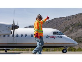 TNDC Airport Services employee gives Central Mountain Air pilot ground safety clearance
