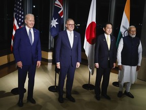 FILE - U.S. President Joe Biden, from left, Australia's Prime Minister Anthony Albanese, Japan's Prime Minister Fumio Kishida, and India's Prime Minister Narendra Modi hold a Quad meeting on the sidelines of the G7 summit, at the Grand Prince Hotel in Hiroshima, western Japan, on May 20, 2023. Japan announced Tuesday, June 6, 2023, that it joined the United States and Australia in signing a $95 million undersea cable project that will connect East Micronesia island nations to improve networks in the Indo-Pacific region where China is increasingly expanding its influence.