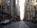 Pedestrians cross the intersection at Bay Street and Wellington Street West in the financial district of Toronto in March 2021.