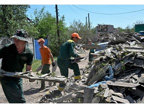 Workers clear debris of houses destroyed by a missile attack, in Kramatorsk, Donetsk Region, on June 19. Photographer: Genya Savilov/AFP/Getty Images