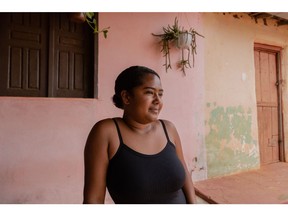 Tamara Leite de Souza, 20, in front of her family's restaurant. Photographer:&ampnbsp;Maria Magdalena Arrellaga/Bloomberg