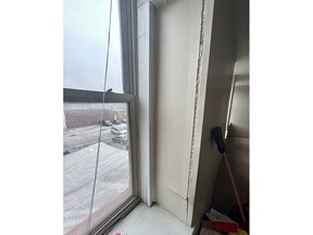 Cracks run along the window frame in an apartment rented by Shauna Dixon before a section of the 116-year-old Davenport apartment building later collapsed in May. The collapse left three dead, and about 50 homeless without their possessions.