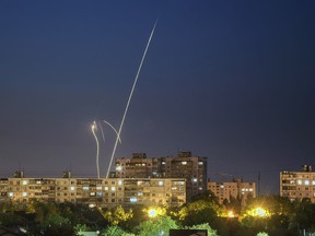 Russian rockets are launched against Ukraine from Russia's Belgorod region, seen from Kharkiv, Ukraine, late Sunday, June 4, 2023.
