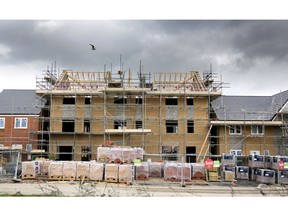 BRISTOL, UNITED KINGDOM - MARCH 18: Construction workers continue to build new houses on a housing development on March 18, 2014 in Bristol, England. A number of housebuilders are now constructing more homes this year than they did during the 2007 market peak, thanks to overseas investment and the government's Help to Buy scheme, which has been extended until 2020, boosting the property market and speeding up the number of new homes being built.