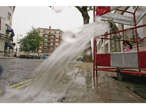 LONDON - MAY 16: A burst pipe spews water onto a street near Lancaster Gate on May 16, 2006 in London, England. One of the driest periods in 70 years has caused restrictions on non-essential use of water to be imposed in the Southeast of England. The restrictions include bans on filling of privately owned swimming pools, watering of gardens & allotments, parks and recreation surfaces.
