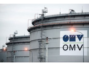 An OMV AG logo sits on the side of a storage tank at the OMV AG Schwechat oil refinery in Schwechat, Austria, on Wednesday, Oct. 21, 2015.  Photographer: Akos Stiller/Bloomberg
