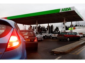 An ASDA Group Ltd. supermarket gas station in Croydon, UK. Photographer: Luke MacGregor/Bloomberg