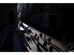 Pedestrians walk along Wall Street near the New York Stock Exchange (NYSE) in New York, U.S., on Monday, Oct. 31, 2016. U.S. stocks rose from a six-week low amid an increase in deal activity as traders assessed the outlook for the presidential election and interest rates in the world's largest economy.