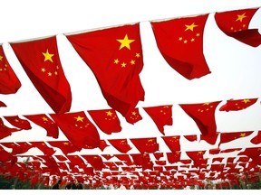 BEIJING, CHINA - SEPTEMBER 30: (CHINA OUT) Chinese people visit a national flag show at Chaoyang park September 30, 2006 in Beijing, China. Chinese people are preparing for National Day Celebration, the 57th anniversary of the founding of People's Republic of China which falls on October 1.