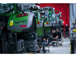 Employee work on the tractor assembly line inside the AGCO GmbH Fendt agricultural machinery factory in Marktoberdorf, Germany, on Wednesday, Nov. 28, 2018. Healthy demand in the manufacturing sector helped boost the number of job vacancies in Germany by 23,000 to a record 1.24 million in the third quarter, according to the latest survey by the IAB Institute for Employment Research. Photographer: Krisztian Bocsi/Bloomberg