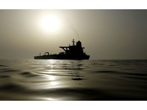 The impounded Iranian crude oil tanker, Grace 1, is silhouetted as it sits anchored off the coast of Gibraltar on Saturday, July 20, 2019. Tensions have flared in the Strait of Hormuz in recent weeks as Iran resists U.S. sanctions that are crippling its oil exports and lashes out after the seizure on July 4 of one of its ships near Gibraltar.