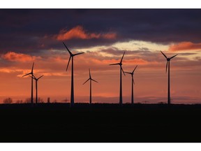 Wind turbines at a wind farm during sunset in Nauen Brandenburg, Germany, on Wednesday, Dec. 30, 2020. It was a pivotal year in the transition toward renewable energy, underpinned by massive government spending pledges and corporations working to burnish their environmental, social and governance credentials.