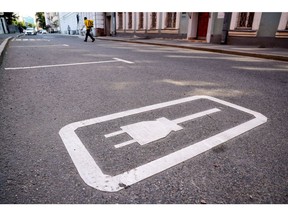 An electric vehicle charging point logo on the ground.