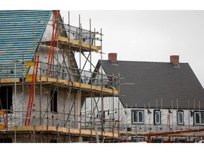 Houses covered with insulation material and scaffolding at a residential construction site in Ebbsfleet, U.K., on Friday, Oct. 8, 2021. The Office for National Statistics are due to release the latest construction output figures of the U.K. on Wednesday.