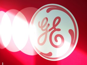 The logo of General Electric is featured on a banner in Plant 23 at the GE Aviation Engine Services facility in Singapore, on Monday, Nov. 22. 2021. General Electric Co.'s engine repair and maintenance business in Singapore is looking to hire more than 300 workers next year as it ramps up operations to meet demand from customers and expands its research into digitalization and automation.Photographer: Ore Huiying/Bloomberg via Getty Images
