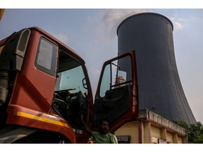 A truck is parked near a cooling tower at the coal-fired NTPC Simhadri thermal power plant in the outskirts of Visakhapatnam, Andhra Pradesh, India, on Sunday, March 20, 2022. India, the world's third biggest emitter of greenhouse gases, plans to more than triple its clean-energy capacity by the end of the decade and zero out emissions by 2070.