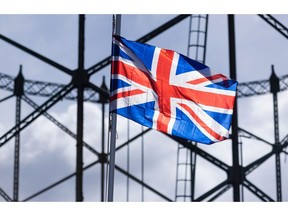 A British Union flag in front of a non-operational gasholder in Dartford, UK, on Friday, May 27, 2022. Britain is in talks to reopen its biggest natural gas storage site as the war in Ukraine threatens to deepen the nation's energy crisis this winter, according to people familiar with the matter. Photographer: Chris Ratcliffe/Bloomberg