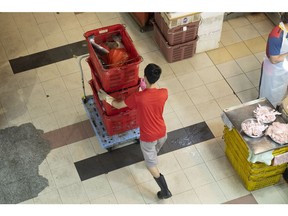 A man delivers goods at the Tekka Centre market in Singapore, on Aug. 21, 2022. Singapore announces its consumer price index (CPI) figures on Aug. 23.