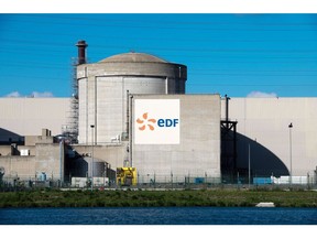 Signage for Electricite de France SA (EDF) at a reactor building in the company's Tricastin Nuclear Power Plant on the Donzere-Mondragon canal in Saint-Paul-Trois-Chateaux, France, on Sunday, Sept. 25, 2022. France President Emmanuel Macron has been making the case for energy savings and more investment in clean power and new nuclear plants to curb fossil fuel use and fight climate change.