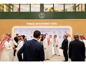 Attendees visit the Public Investment Fund (PIF) booth on day two of the Future Investment Initiative (FII) conference in Riyadh, Saudi Arabia, on Wednesday, Oct. 26, 2022. Saudi Arabia hopes the FII will put Riyadh on the map as a global destination for deals, while also improving domestic investment, which has been limited.