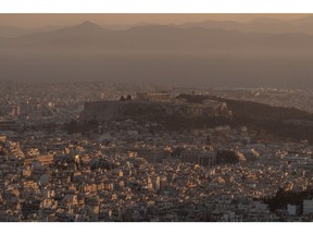 Buildings surround Acropolis Hill on the skyline in Athens.