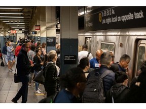 Commuters at the Times Square subway station in New York, US, on Friday, May 19, 2023. New York City Transit reported 12.4 million people entered the subway during the last work week, down 1.5% from the previous week.