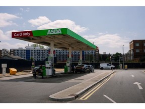 Customers use fuel pumps at an ASDA Group Ltd. supermarket in London, UK, on Tuesday, May 30, 2023. Asda agreed to buy EG Group's UK and Ireland gas-station business in a move that aims to create a convenience retailing empire in one of the world's most competitive food markets.