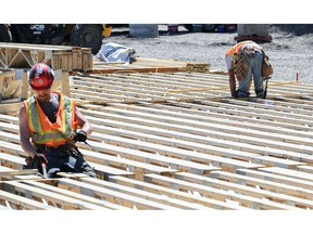 Workers at the site of a residential building under construction in Montreal, Quebec, Canada, on Wednesday, May 31, 2023. Canada's population is swelling, more than a million newcomers arrived last year, bringing attention once again to a shortage of housing stock and prompting some buyers to make aggressive bids.