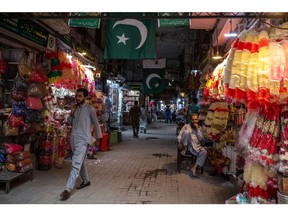 Shoppers pass street stalls in Lahore, Pakistan, on Thursday, June 1, 2023. Pakistan's inflation has hit another record high, making it Asia's fastest for a second month, just days before the national budget is due to be unveiled by a government facing unprecedented economic challenges.