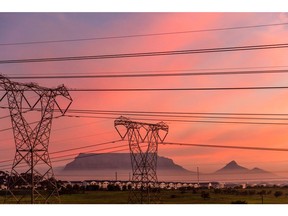 Table Mountain beyond high-voltage electricity transmission towers in Cape Town, South Africa, on Thursday, June 1, 2023. Cape Town, South Africa's second-largest city, is in talks with Eskom Holdings SOC Ltd. to take over the supply of electricity in areas of the metro served by the state power utility.
