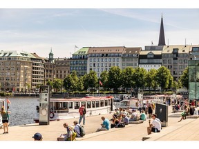 Pedestrians relax on the bank of Alster lake in Hamburg, Germany, on Friday, June 9, 2023. A 25-bps interest rate increase from the European Central Bank on June 15 is basically a done deal.