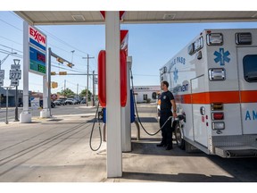 EAGLE PASS, TEXAS - JUNE 29: Emergency Medical Technician William Dorsey fills the EMT ambulance with gas after responding to a call on June 29, 2023 in Eagle Pass, Texas. Maverick County Law Enforcement and paramedics are responding to larger volumes of medical-related calls as temperatures soar across the region. Extreme temperatures across the state have prompted the National Weather Service to issue excessive heat warnings and heat advisories that affect more than 40 million people. The southwestern region of the state has suffered record-breaking 120-degree heat indexes in recent days, with forecasters expecting more of the same.