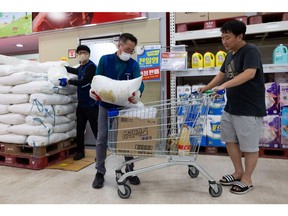 A customer buys a 20kg bag of salt at a supermarket in Seoul on July 4.