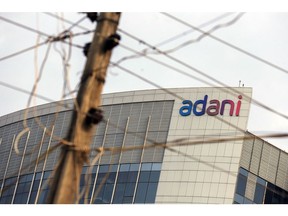 Signage atop the Adani Group headquarters in Ahmedabad, India, on Saturday, July 15, 2023. Indian billionaire Gautam Adani's flagship firm raised 12.5 billion rupees ($152 million) through notes, its first such local-currency bond sale since it was targeted by short seller Hindenburg Research in January. Photographer: Dhiraj Singh/Bloomberg