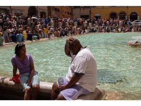 Tourists use water to keep cool at the Trevi Fountain during a heat wave in Rome on July 17.  Photographer: Gaia&ampnbsp;Squarci/Bloomberg