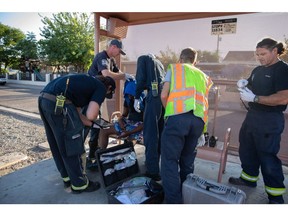 Firefighters assist a resident during a heat wave in Phoenix, Arizona, US, on July 20. Photographer: Caitlin O'Hara/Bloomberg