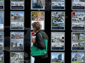 A woman inspects listings at a real estate agency in Melbourne. Australia has been the top spot for wealthy Chinese buying properties abroad this year.